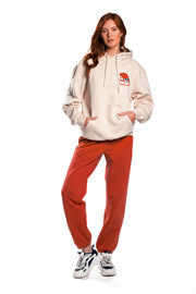 Misfits Gaming Logo in red and white on sand hoodie front on female model